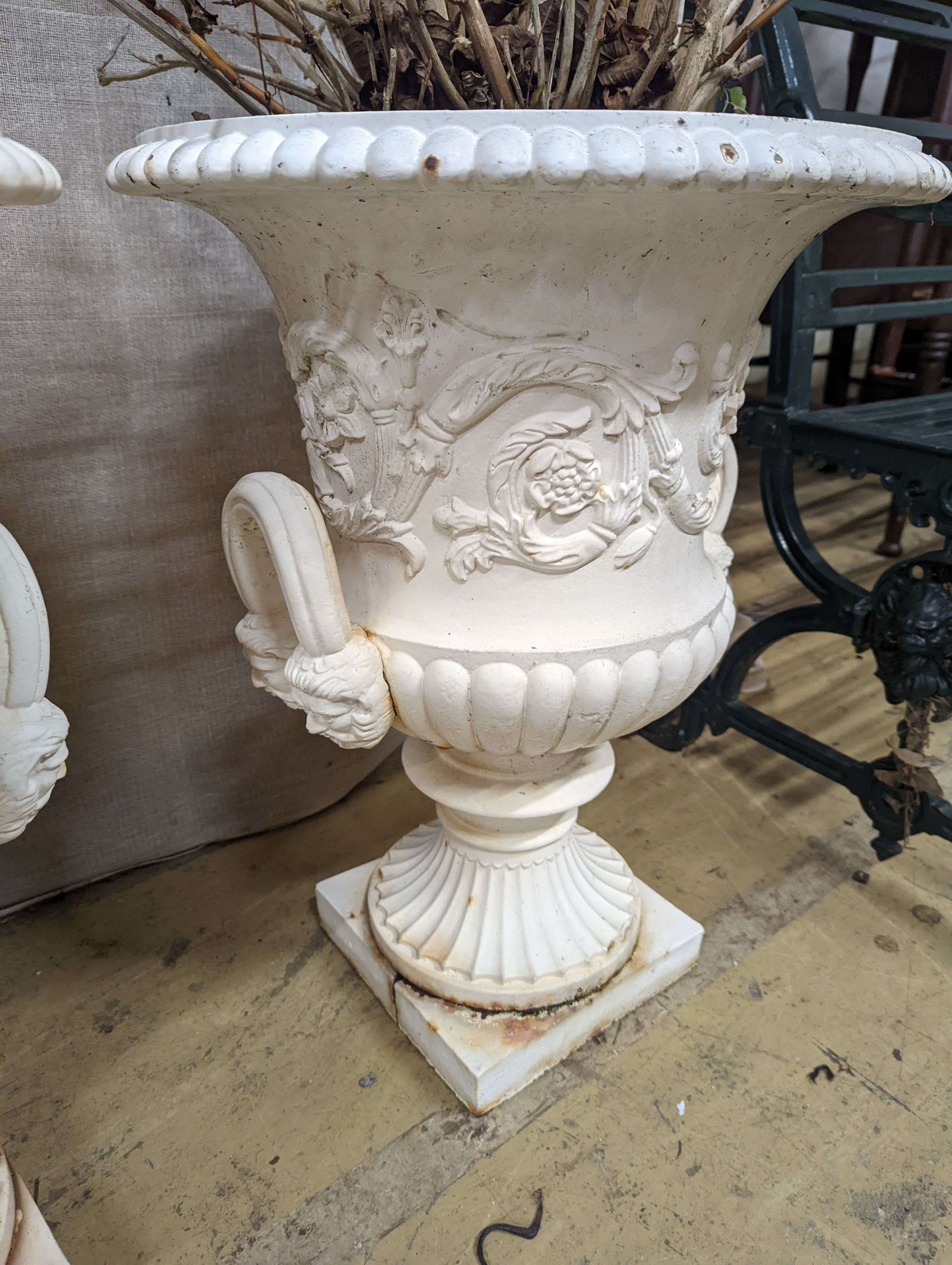 A pair of Victorian style white painted cast metal campana garden urns, height 62cm